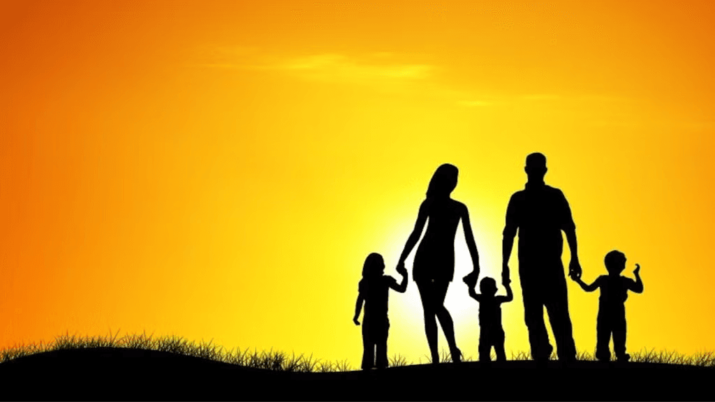 Silhouette of a family walking together at sunset